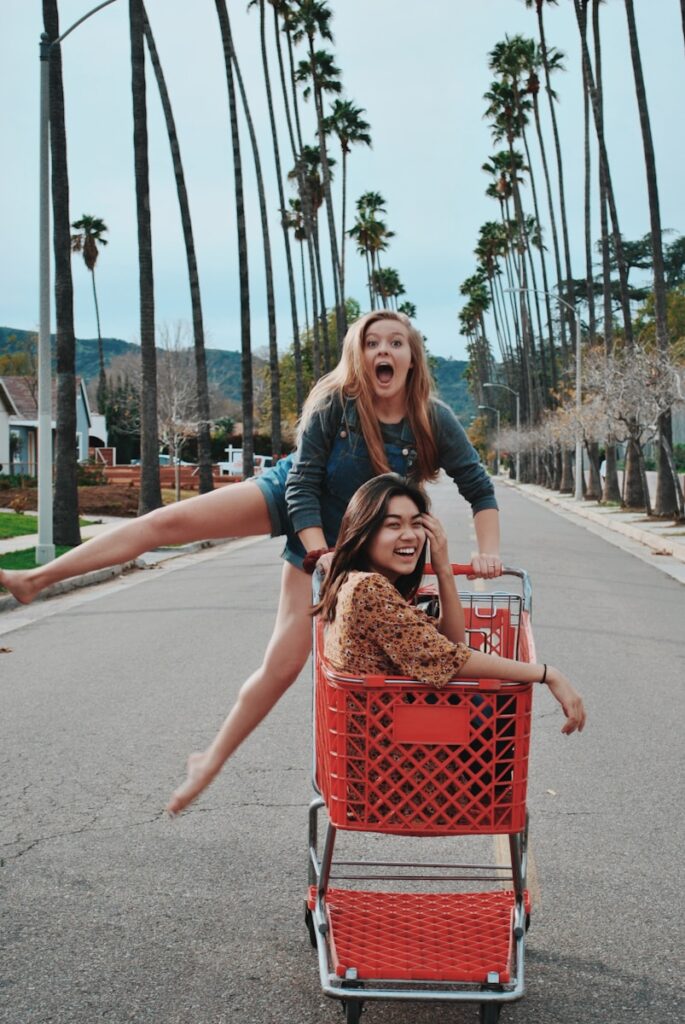 two women on shopping cart